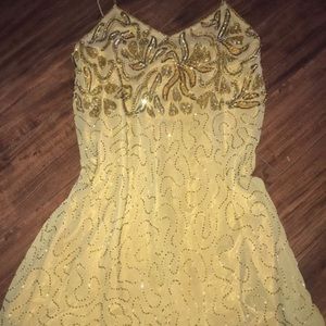A gold dress with gold beads